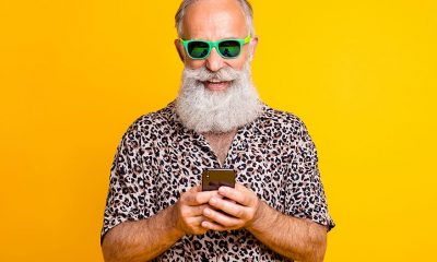 man wearing sunglasses holding phone