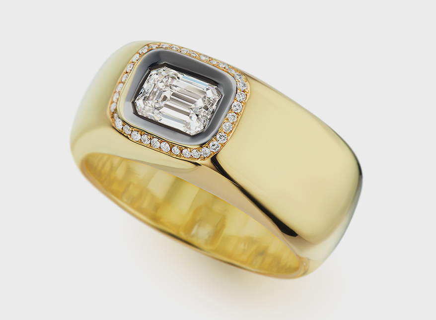 Nancy Newberg 18K yellow gold ring with black ruthenium trim, emerald cut diamond, and accent diamonds.