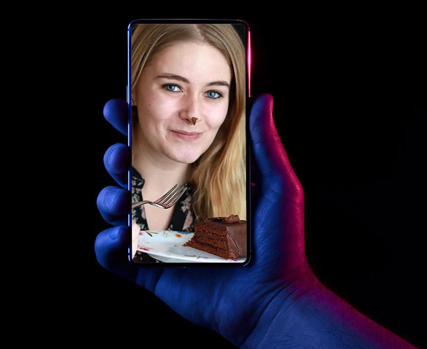 photo of lady on phone eating cake