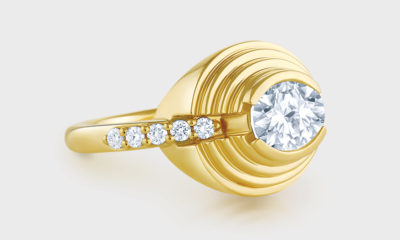 18K yellow gold ring with oval diamond and diamond accents.