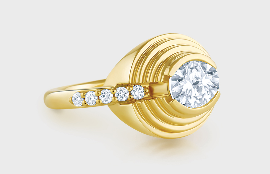 18K yellow gold ring with oval diamond and diamond accents.