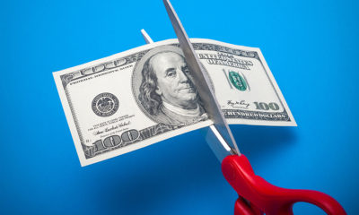scissors cutting dollar bill