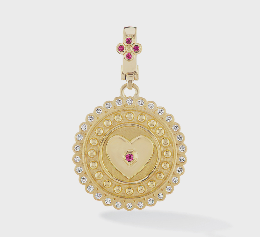 Orly Marcel 18K gold heart pendant with ruby center.
