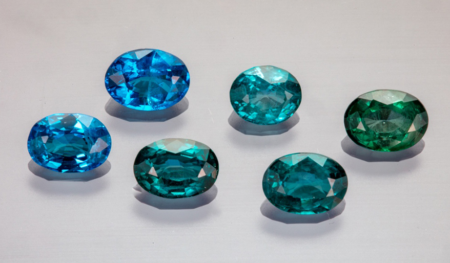 Suite of faceted nickel-diffused spinel (0.674–1.009 ct) showing the range of color from blue to bluish green. Photo by Aaron Palke and Diego Sanchez, ãGIA