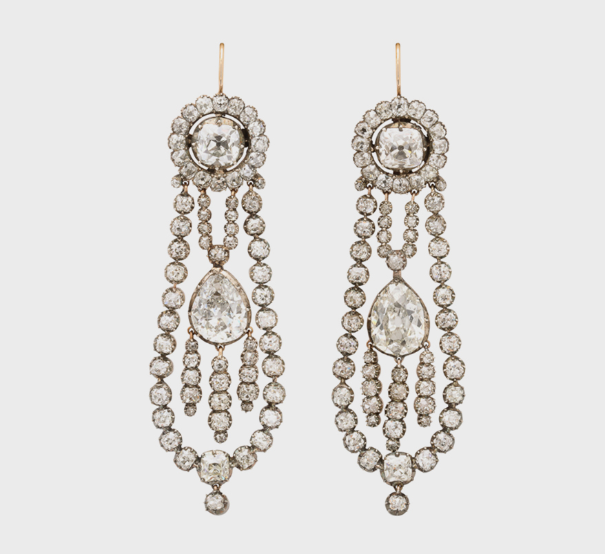 A La Vieille Russie Georgian era diamond drop earrings with old mine cut diamond articulated swing-framed drop and fringe pendant earrings. English, late 18th century.